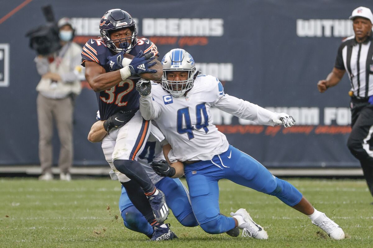 FILE - Chicago Bears running back David Montgomery (32) is tackled by Detroit Lions middle linebacker Alex Anzalone, back, and linebacker Jalen Reeves-Maybin (44) during the first half of an NFL football game, Sunday, Oct. 3, 2021, in Chicago. The Chicago Bears will once again be without star linebacker Khalil Mack, though they might have running back David Montgomery available when they visit the Pittsburgh Steelers on Monday night Nov. 8, 2021. (AP Photo/Kamil Krzaczynski, File)