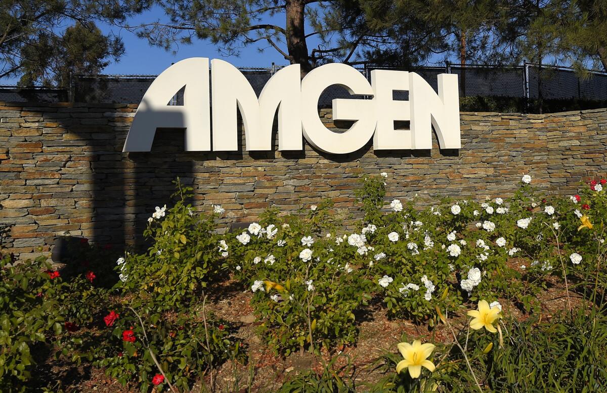 A sign on a stone wall says "Amgen."  