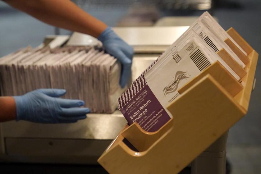 FILE - In this Nov. 1, 2020, file photo, envelopes containing ballots are shown at a San Francisco Department of Elections at a voting center in San Francisco. California's leaders are considering making voting by mail a permanent option for all of its registered voters. This year, the state required county elections officials to mail a ballot to all registered voters ahead of the election. (AP Photo/Jeff Chiu, File)