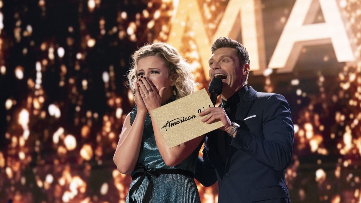 In this May 21, 2018 photo provided by ABC, Maddie Poppe, left, reacts with Ryan Seacrest after she was announced the winner of this year's "American Idol" in Los Angeles.