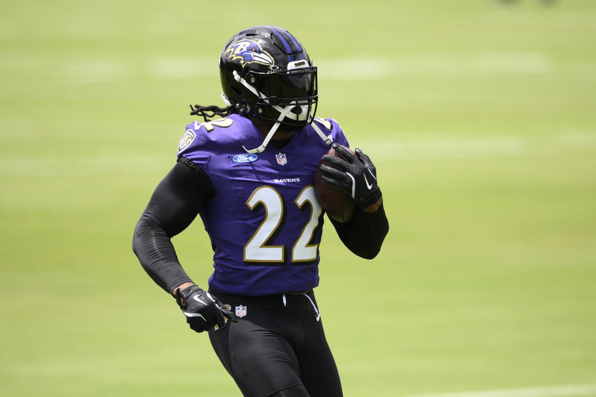 Baltimore Ravens running back Derrick Henry (22) works out during practice.