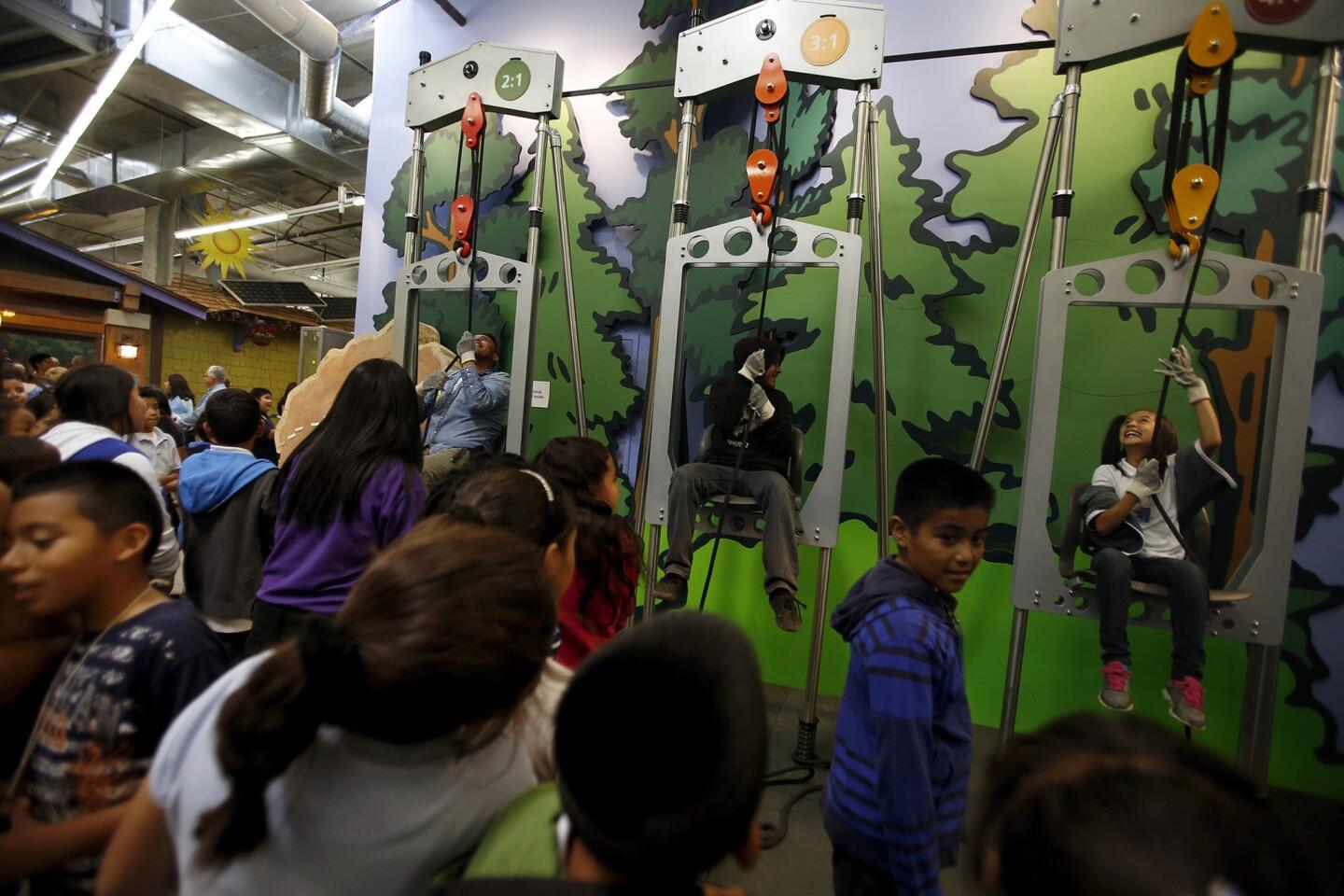 Students have fun with the power of pulleys on opening day of the Discovery Cube Los Angeles science museum in the San Fernando Valley.