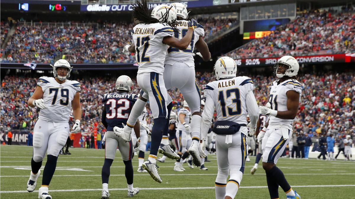 Chargers wide receiver Travis Benjamin leaps to celebrate his touchdown catch with Melvin Gordon during the second half against the New England Patriots on Oct. 29.