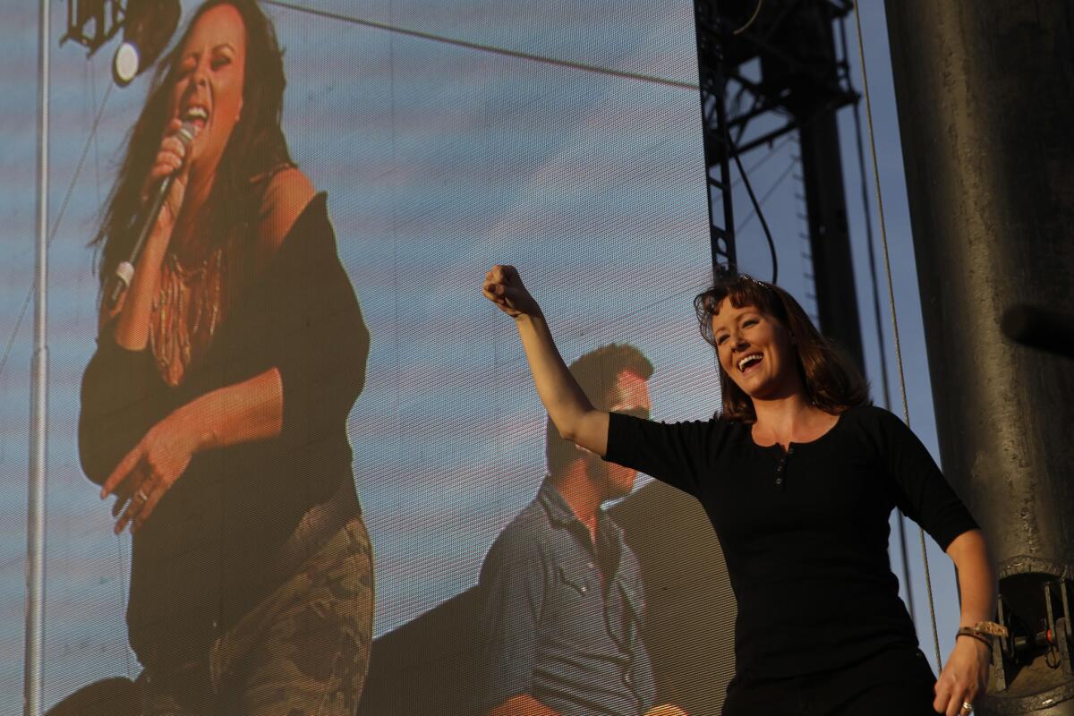 Sara Groves, right, sign language interpreter, signs as Sara Evans sings on the Mane stage on the third and final day of the sold-out Stagecoach Country Music Festival at the Empire Polo Club in Indio on Sunday.