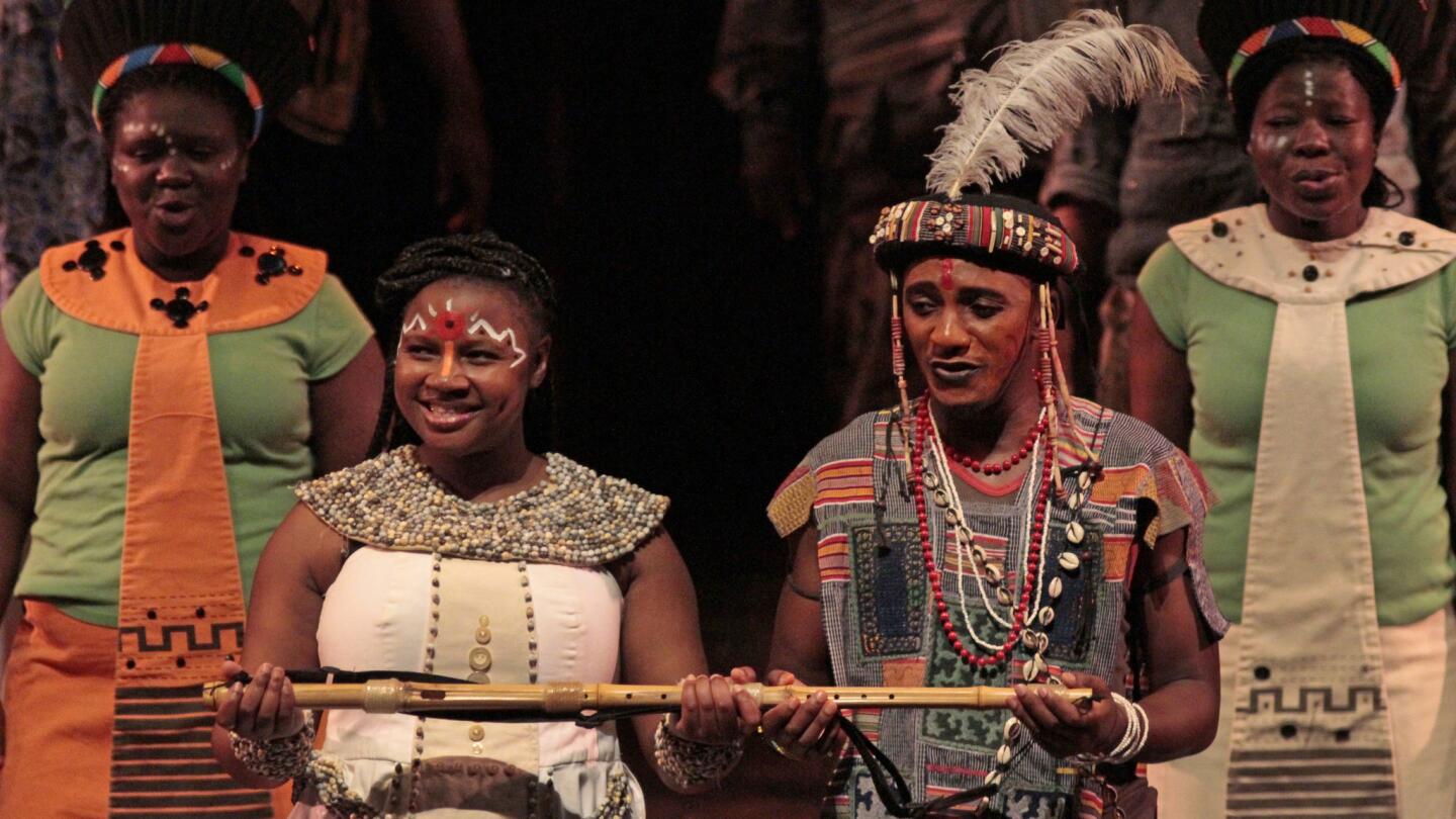 Mhlekazi "Wha Wha" Mosiea as Tamino, right, and Zolina Ngejane as Pamina with the cast in Isango Ensemble's "The Magic Flute" at the Broad Stage in Santa Monica on Oct. 08, 2014. Mozart's "The Magic Flute" by the Isango Ensemble from Cape Town, South Africa, is now touring the U.S.