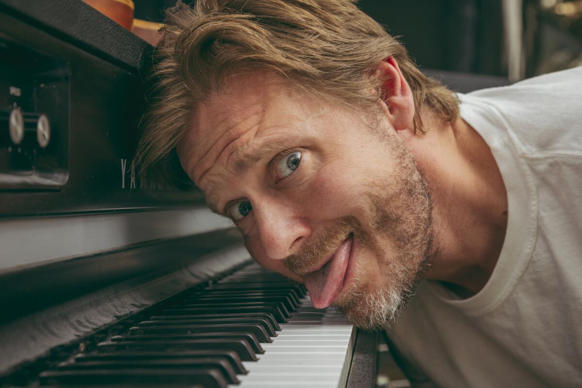 Man sticking his tongue out at his piano, funny expression