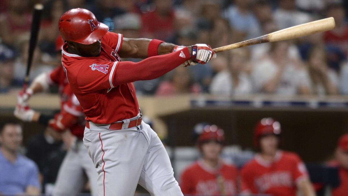 Angels' Justin Upton hits a two-run home run during the fifth inning of a baseball game against the San Diego Padres in San Diego. 
