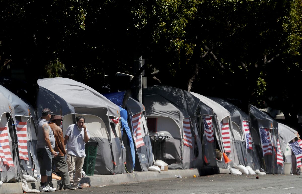  American flags decorate tents at an encampment of homeless veterans