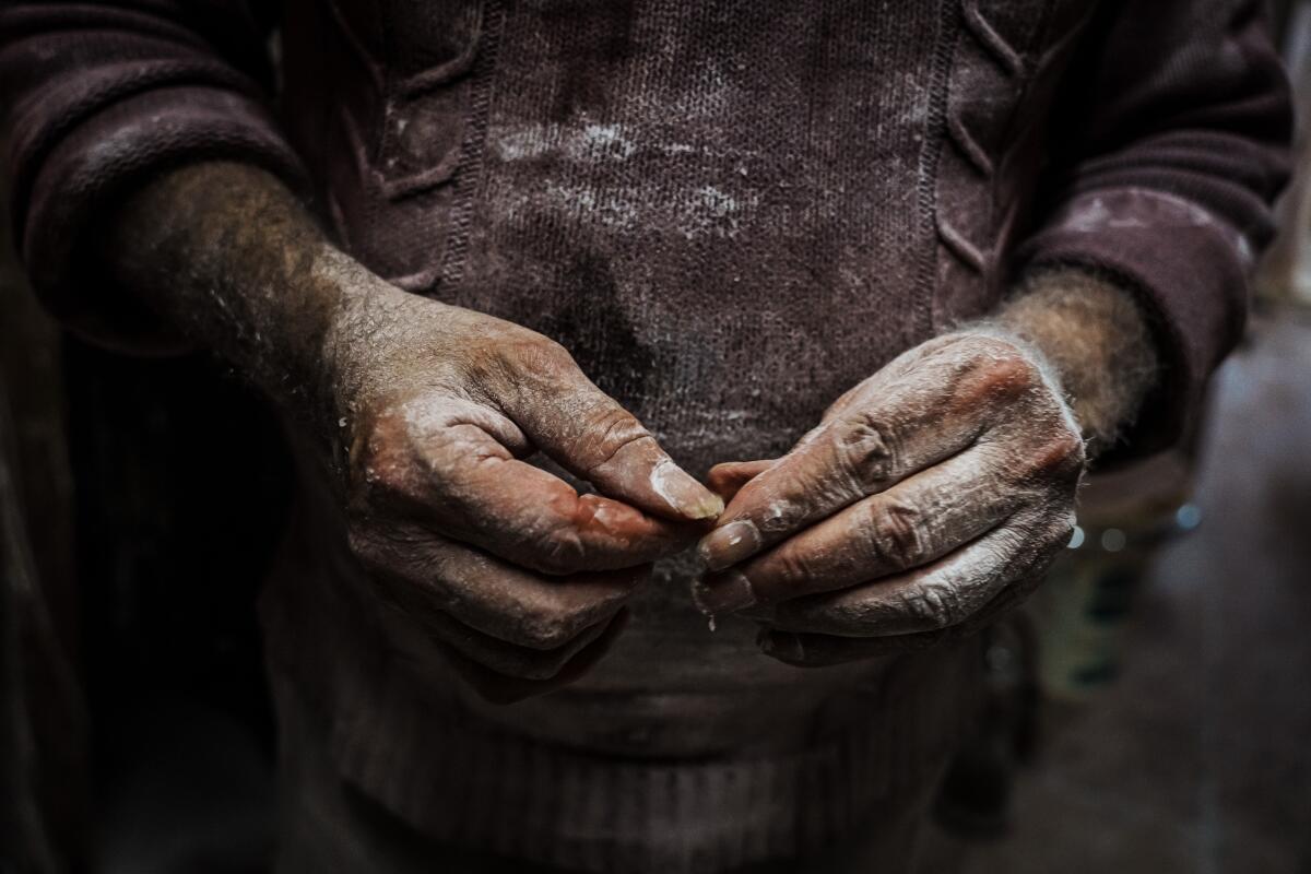 Powdered hands of a sweets maker