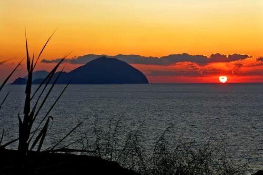 The sun sets beyond Filicudi, another Aeolian island west of Salina in the Tyrrhenian Sea.
