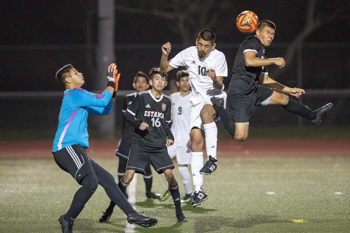 Estancia’s Marcos Arreola, right, goes up for a header against Saddleback’s Victor Lima during an Orange Coast League match on Jan. 18, 2019.