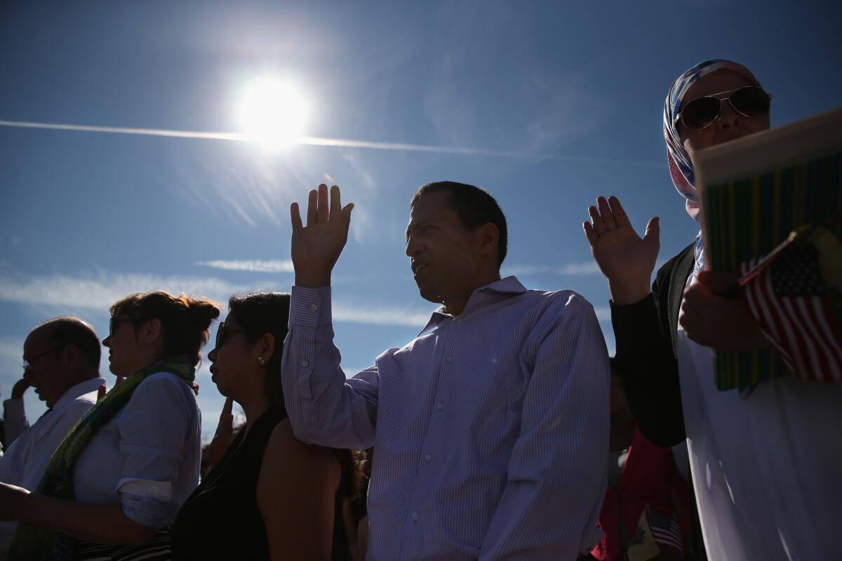 Immigrants from 30 countries take part in a naturalization ceremony earlier this month at Liberty State Park in Jersey City, N.J.