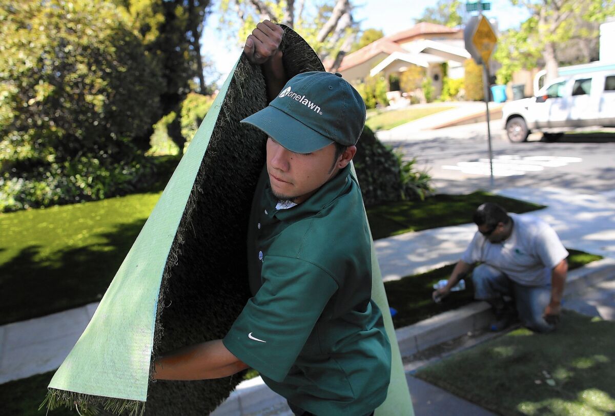 A section of artificial turf is installed at a home in Burlingame, Calif. As California enters its fourth year of severe drought, artificial lawns have emerged as a water-saving alternative to traditional yards.