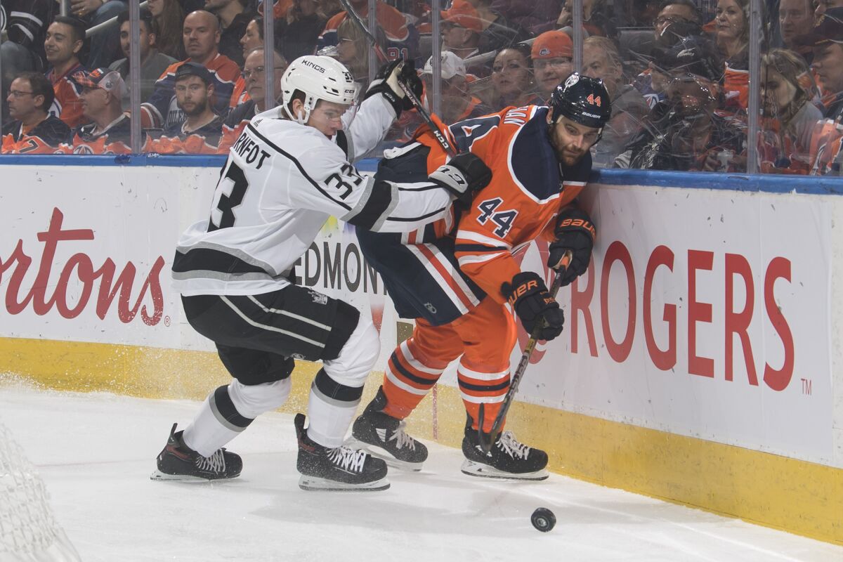 The Kings' Tobias Bjornfot, left, and the Oilers' Zack Kassian near the boards in Edmonton on Oct. 5.