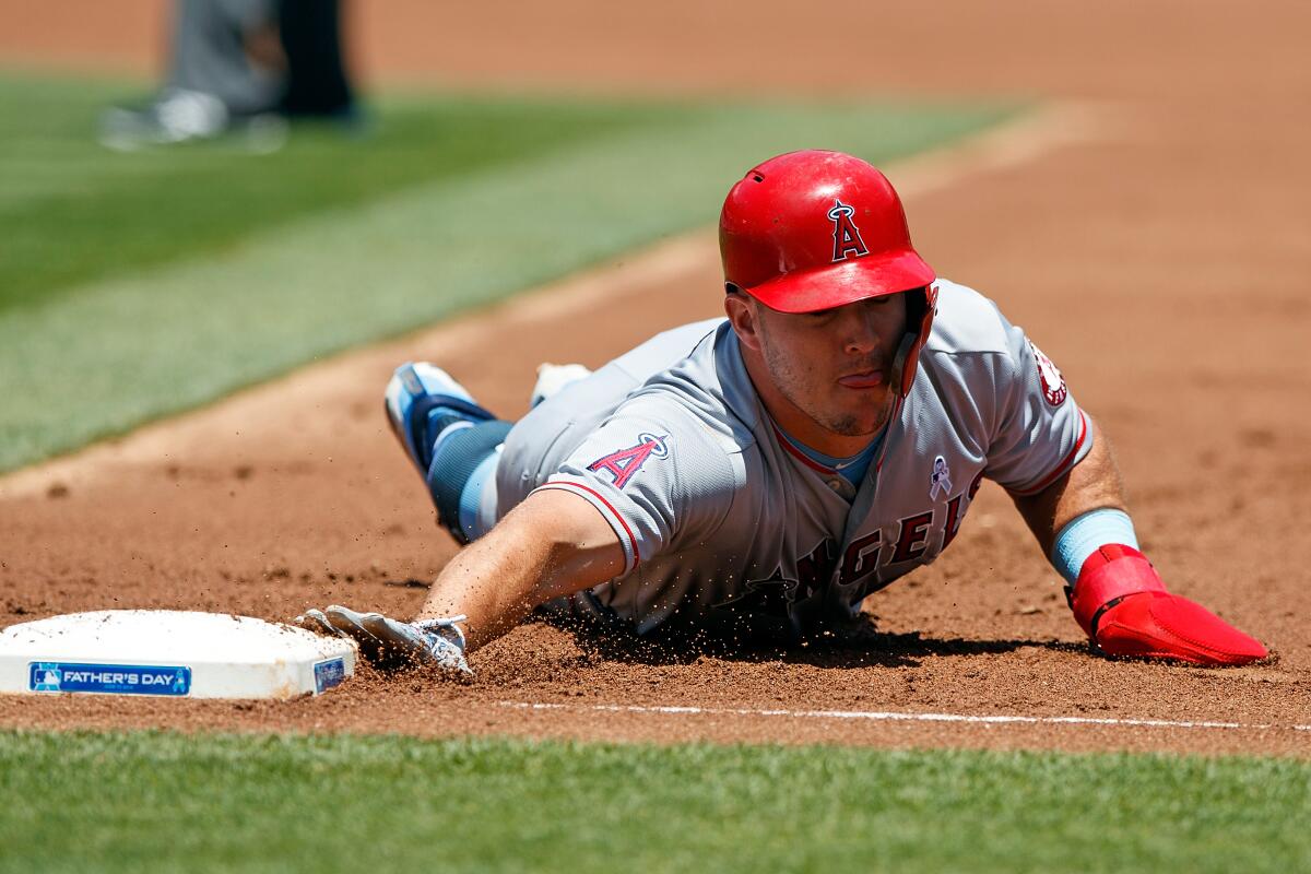 Angels center fielder Mike Trout slides back to first base during a game.