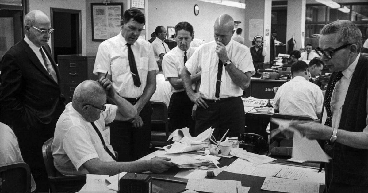 Nov. 22, 1963: Los Angeles Times editors cluster around news editor Mort Helm's desk on the day of President John F. Kennedy's assassination.