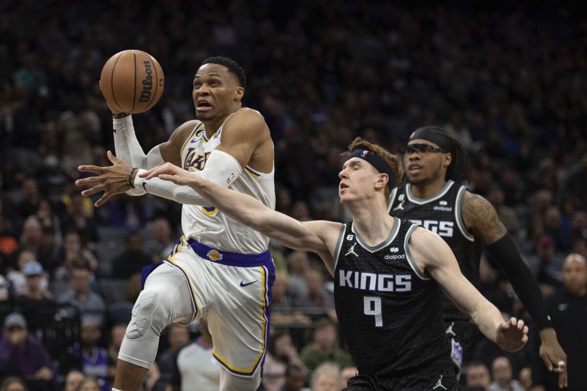 Lakers guard Russell Westbrook is fouled by Kings guard Kevin Huerter (9) on a drive Jan. 7, 2023.