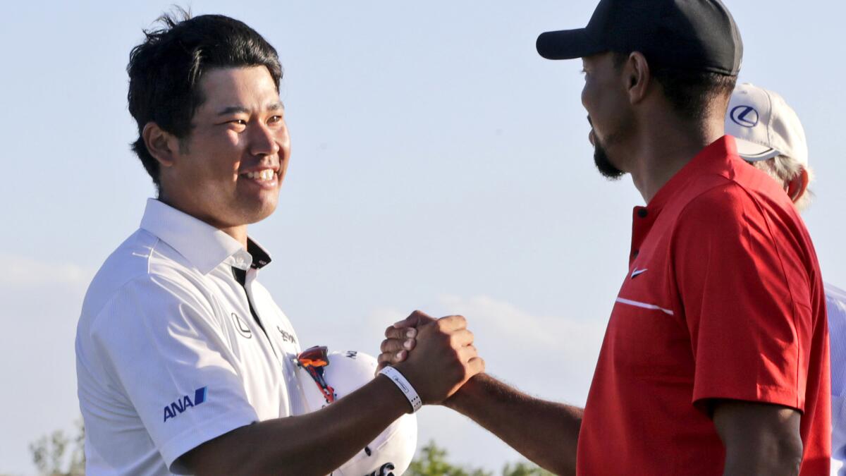 Hideki Matsuyama is congratulated by Tiger Woods after winning the Hero World Challenge on Sunday.