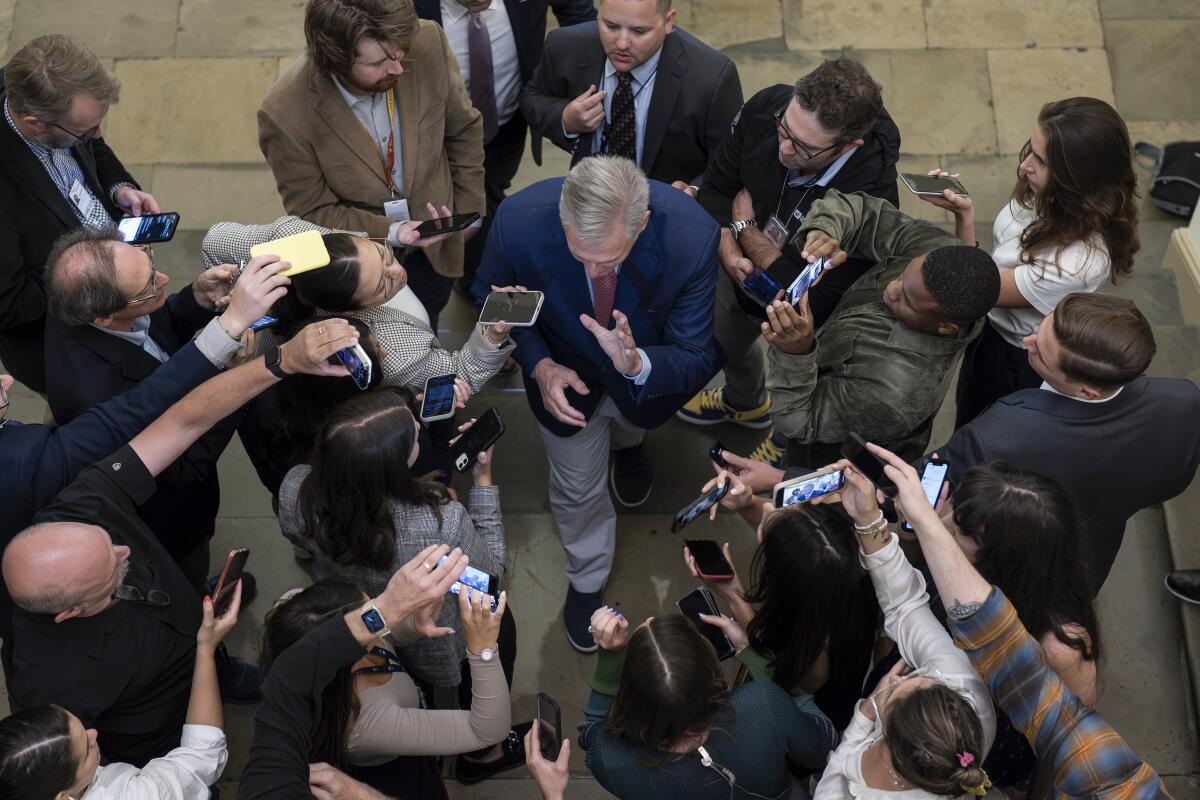 Aerial view of a man surrounded by reporters