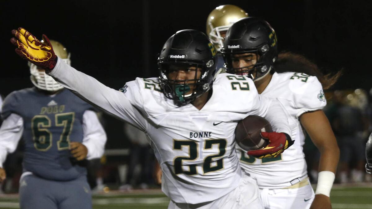 Narbonne linebacker Raymond Scott (22) recovers a fumble in the third quarter against Long Beach Poly High School on Sept. 2, 2016.
