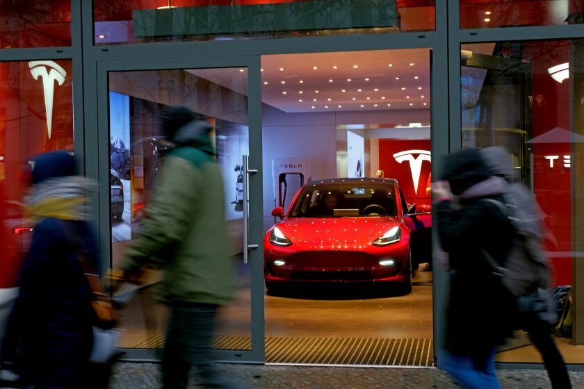 BERLIN, GERMANY - JANUARY 04: People walk past a Tesla dealership on January 4, 2019 in Berlin, Germany. Tesla is expected to soon begin deliveries of the Model 3 in Europe even though the car has not yet been officially approved by European authorities. (Photo by Sean Gallup/Getty Images) ** OUTS - ELSENT, FPG, CM - OUTS * NM, PH, VA if sourced by CT, LA or MoD **