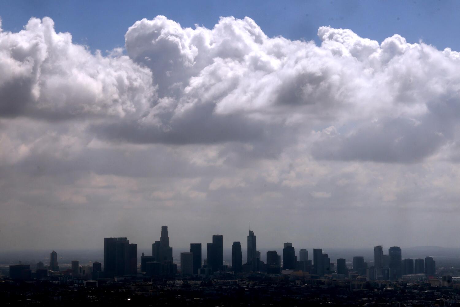 LOS ANGELES, CA - OCTOBER 3, 2025 -- Storm clouds pass over the Los Angeles skyline as seen from the Griffith Observatory on October 3, 2025. (Genaro Molina/Los Angeles Times)