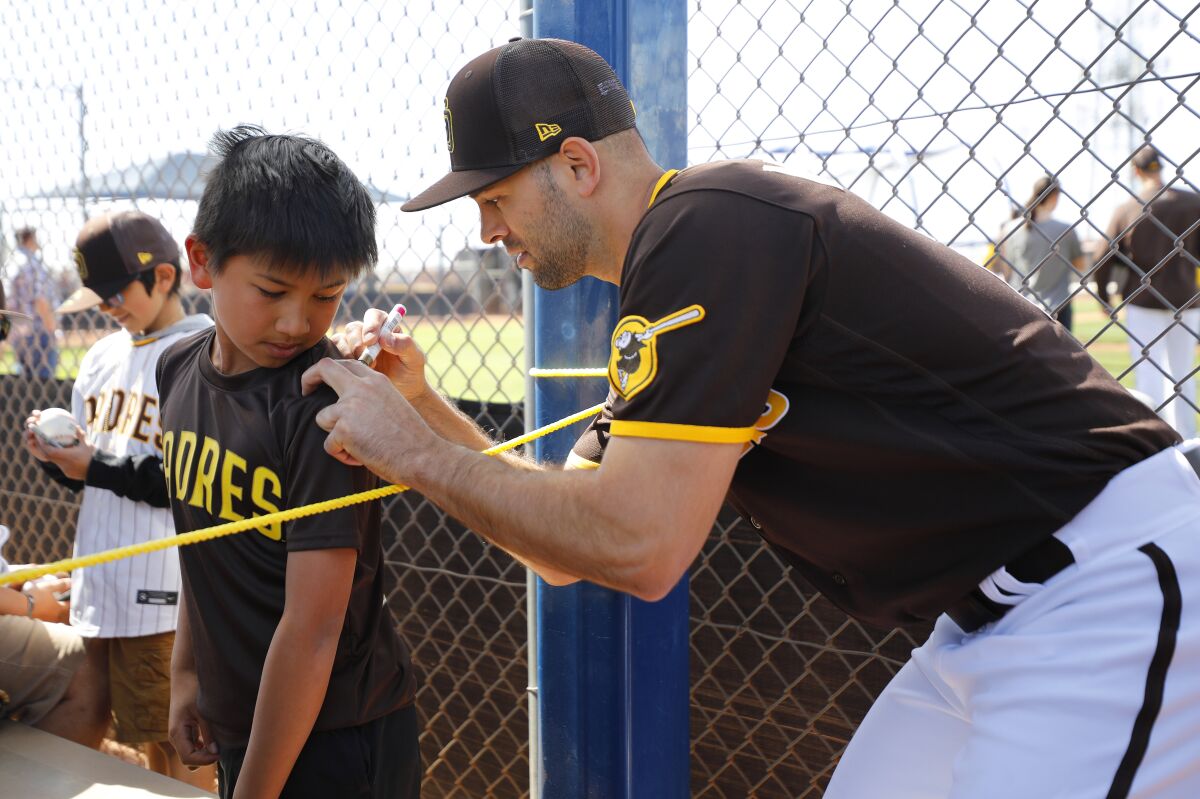 Nick Martinez, signing autograph for a fan at a spring training practice last month, makes his Padres debut Monday night.