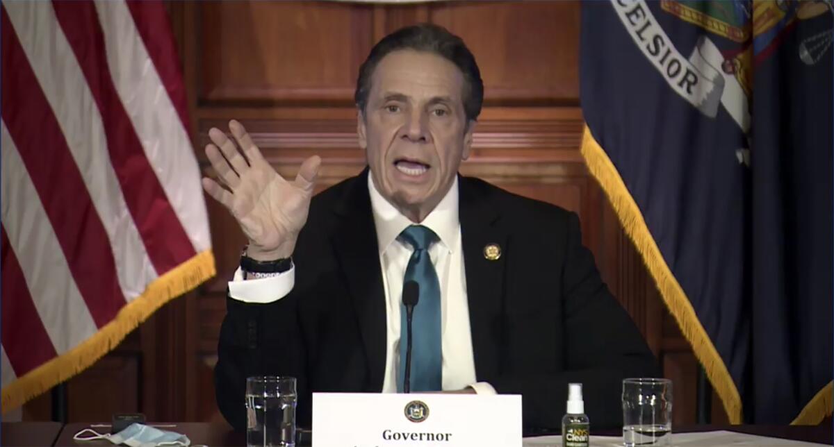 Gov. Cuomo gestures with his right hand during a news conference.