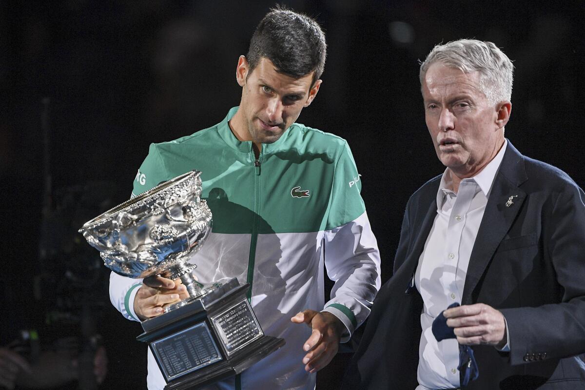 Novak Djokovic, left, stands with Australian Open tournament director Craig Tiley.