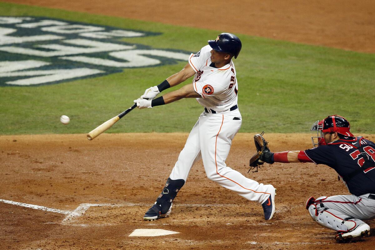 Houston Astros' Michael Brantley (23) hits a single against the Washington Nationals during the third inning in Game 2 of the World Series in Houston.