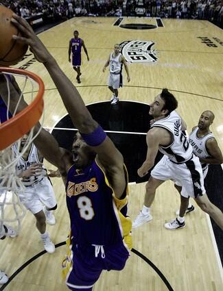 Lakers guard Kobe Bryant scores past San Antonio Spurs defenders Tim Duncan, Manu Ginobili, and Bruce Bowen.