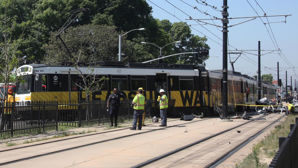 The crash derailed the Expo Line train and totaled the car. The car's driver had to be cut from the vehicle.