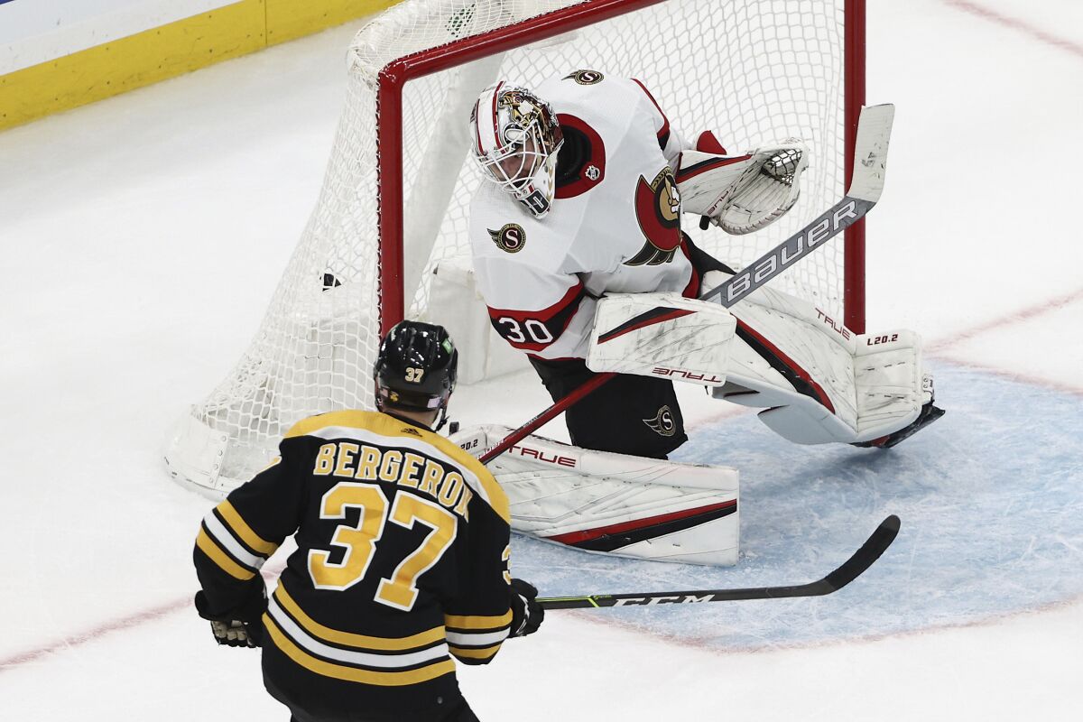 Boston Bruins' Patrice Bergeron scores on Ottawa Senators goaltender Matt Murray during the second period of an NHL hockey game Tuesday, Nov. 9, 2021, in Boston. (AP Photo/Winslow Townson)
