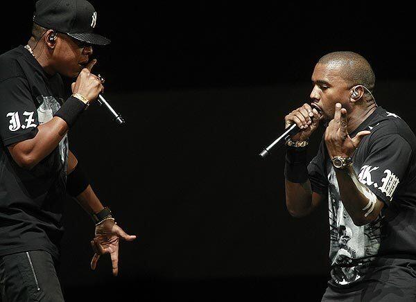 Jay-Z, left, and Kanye West on stage Sunday night at the Staples Center for the first of three nights of their"'Watch the Throne" tour in Los Angeles.