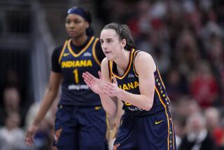 Indiana Fever guard Caitlin Clark reacts in the second half of a WNBA basketball game.