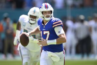 Buffalo Bills quarterback Josh Allen (17) scrambles as he looks to throw the ball during an NFL football game against the Miami Dolphins, Sunday, Sept. 25, 2022, in Miami Gardens, Fla. (AP Photo/Doug Murray)