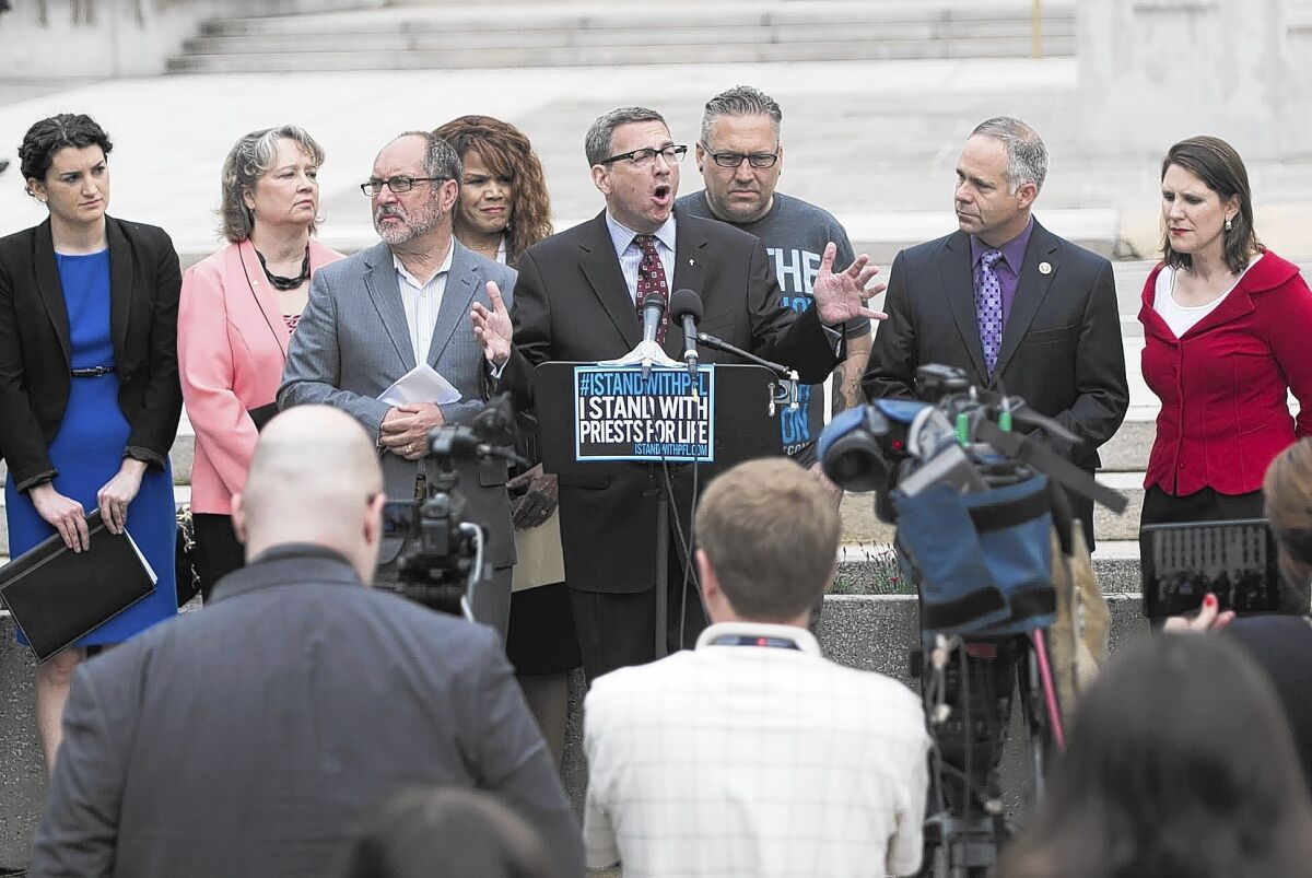 The Rev. Rob Schenck, center, president of Faith and Action in the Nation's Capitol, speaks at a protest in Washington.