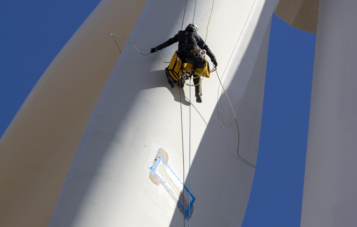 Rope Partner's Matthew Kelly adjusts a positioning ring line.