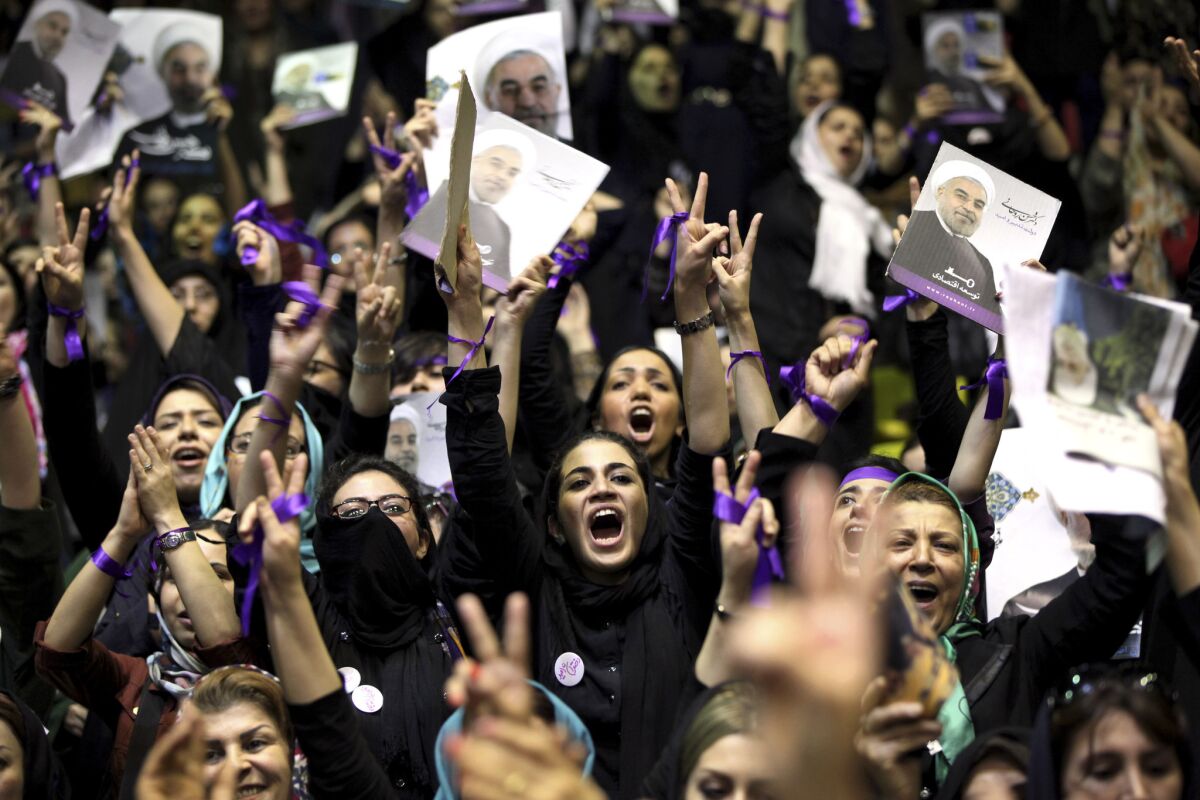 Female supporters of Iranian presidential candidate Hassan Rowhani chant slogans at a campaign rally in Tehran.