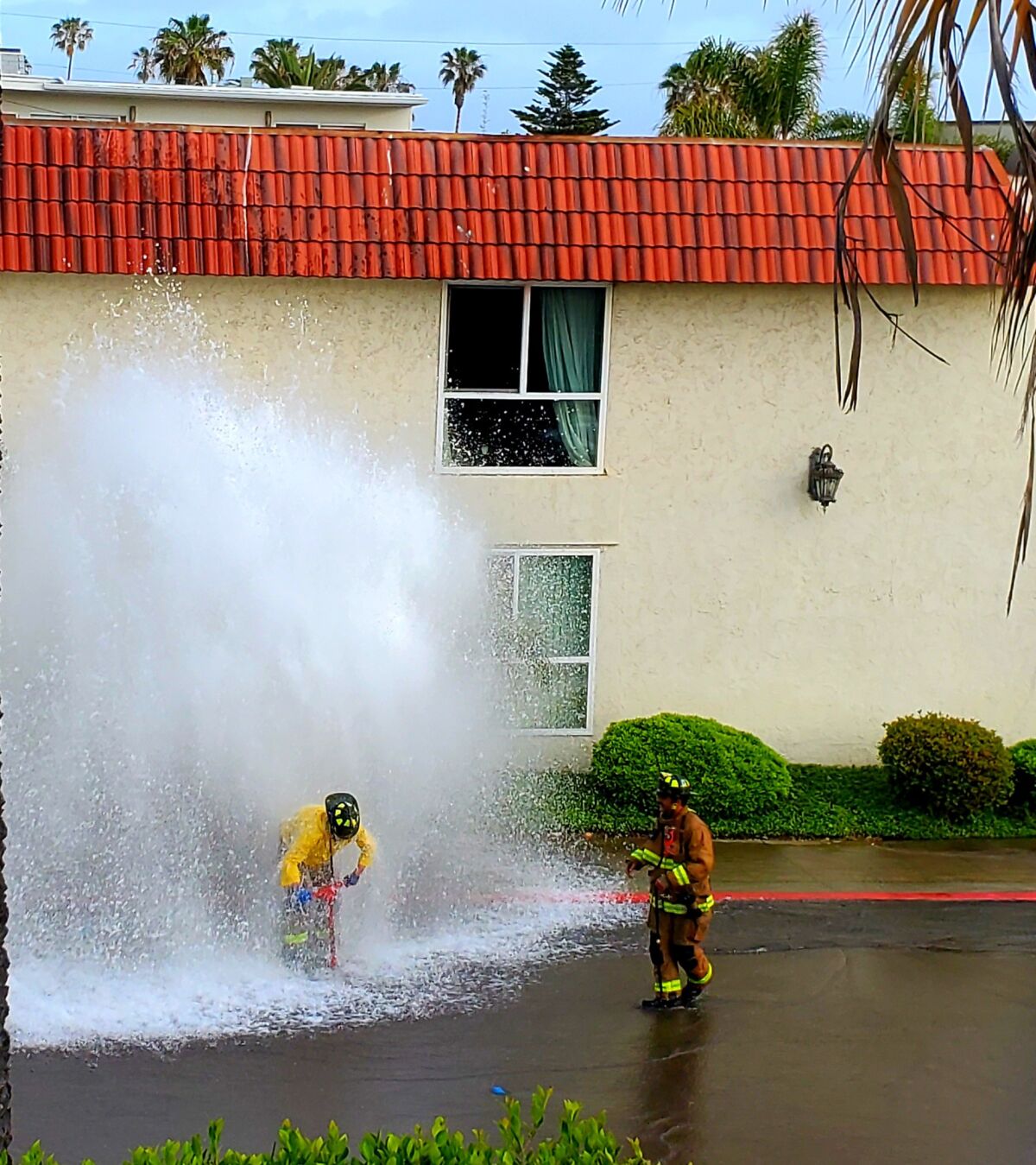 Emergency personnel work to shut off a broken fire hydrant in the 300 block of Bonair Street on May 20.
