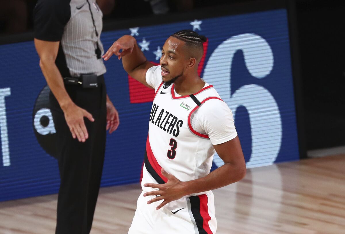 Portland Trail Blazers guard CJ McCollum (3) celebrates after scoring a 3-pointer against the Los Angeles Lakers during the first half of Game 3 of an NBA basketball first-round playoff series, Saturday, Aug. 22, 2020, in Lake Buena Vista, Fla. (Kim Klement/Pool Photo via AP)