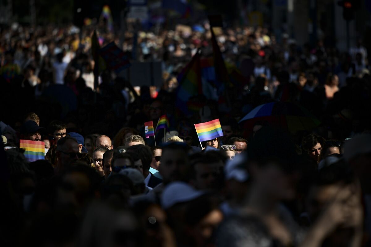 FILE - People march during a gay pride parade in Budapest, Hungary, Saturday, July 24, 2021. The European Union's executive intensified its legal standoff with Hungary on Friday, July 15, 2022 by taking the country to the EU's highest court over a restrictive law on LGBT issues and media freedom. (AP Photo/Anna Szilagyi, File)