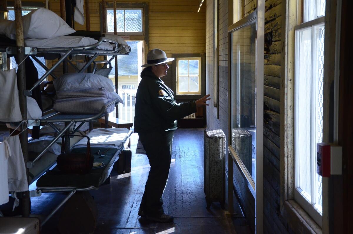 Angel Island in San Francisco Bay housed the immigration station that processed immigrants from China and other Pacific countries from 1910-1940. Here, a state parks ranger points out wall markings.