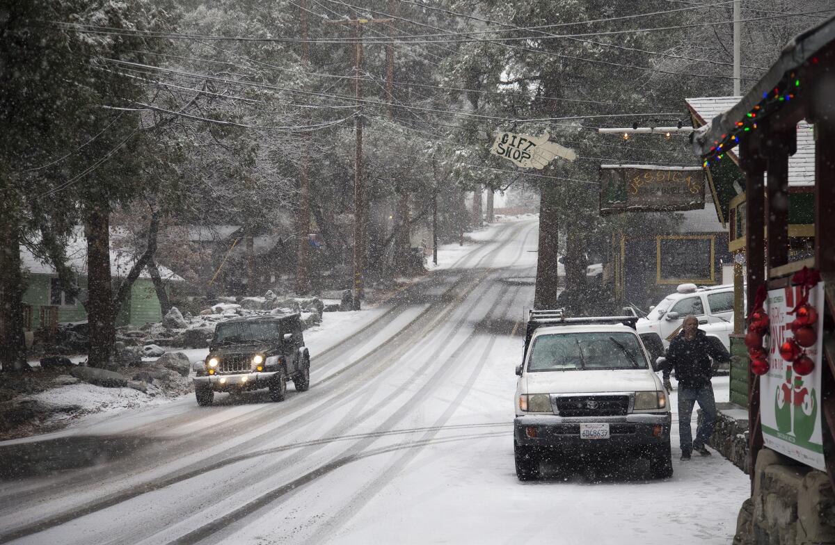 Mountain roads are slick as snow falls on Valley of the Falls Drive in the San Bernardino National Forest on Dec. 30.