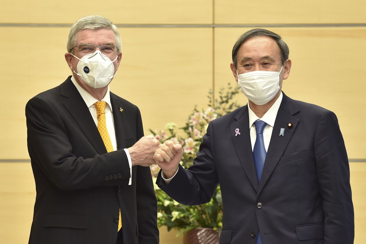International Olympic Committee President Thomas Bach and Japanese Prime Minister Yoshihide Suga in Tokyo on Monday.