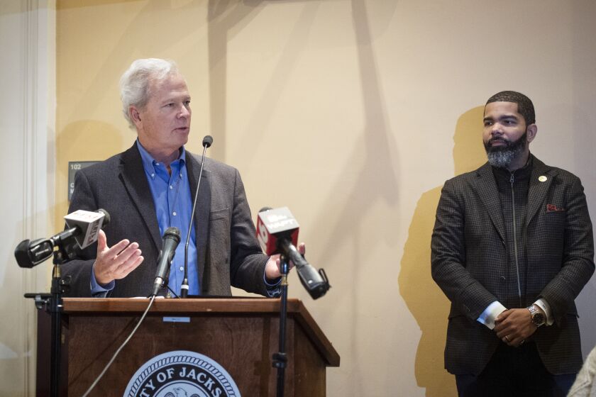 Ted Henifin, left, the City of Jackson water system third-party administrator, addresses media questions during a news conference at City Hall as Jackson Mayor Chokwe Antar Lumumba listens on Monday, Dec. 5, 2022, in Jackson, Miss. (Barbara Gauntt/The Clarion-Ledger via AP)