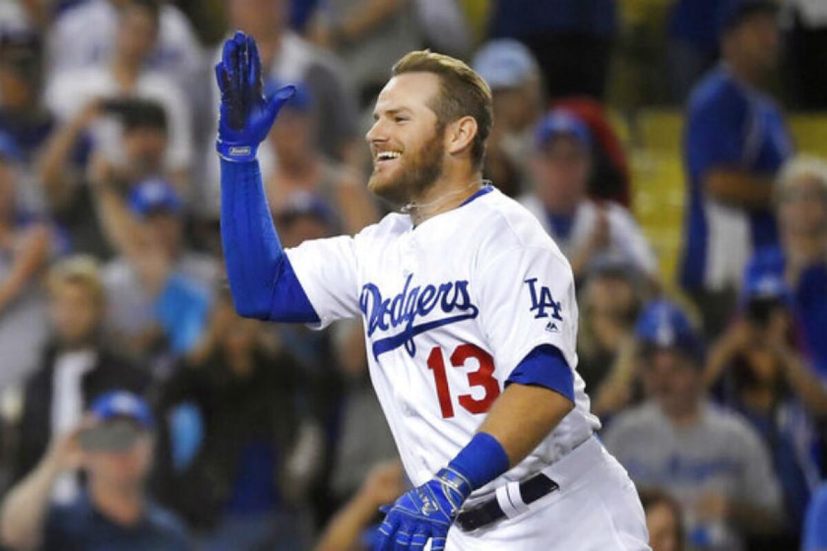 Max Muncy tosses his helmet after hitting a game-winning home run in the 10th inning Wednesday.