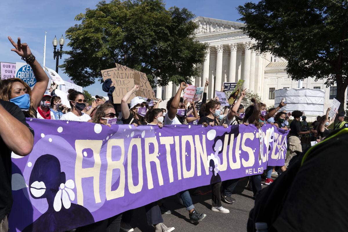 Abortion-rights demonstrators rally outside the U.S. Supreme Court during the Women's March in Washington on Oct. 2. 