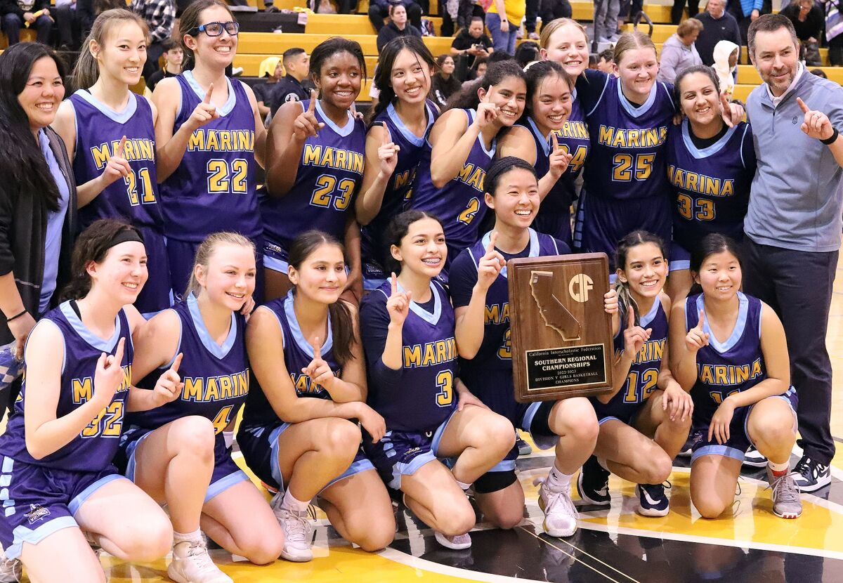 The Marina girls' basketball team poses for a picture with the CIF State Southern California Regional Division V plaque.