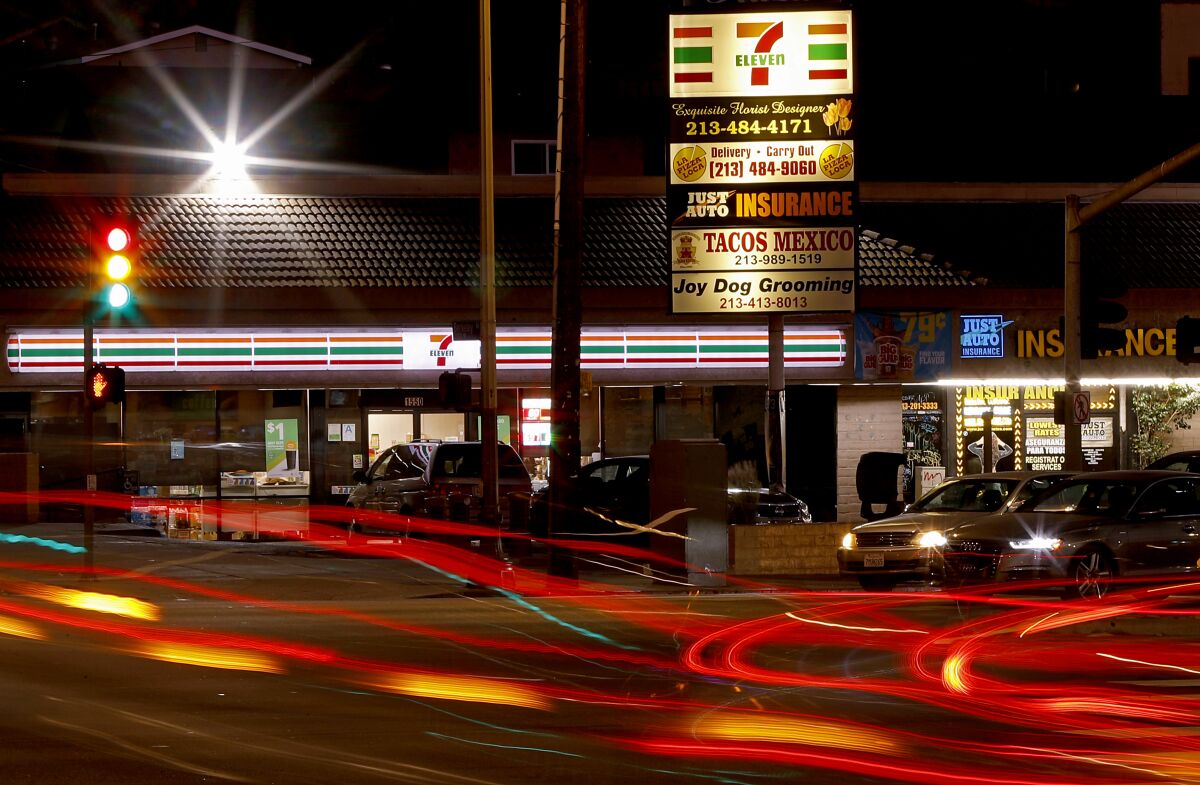 Traffic streams past a 7-Eleven store along Glendale Boulevard in Los Angeles.